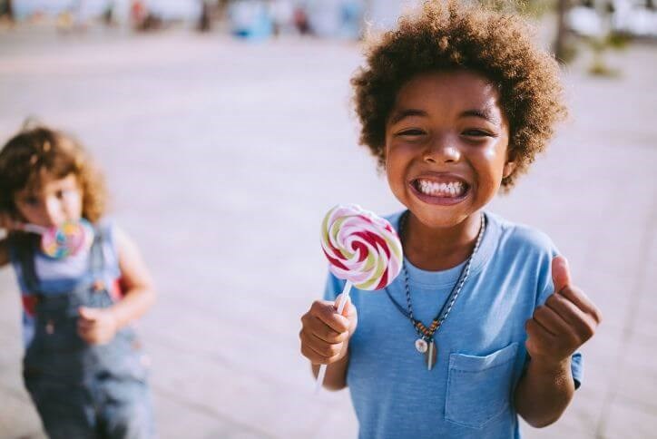 Excited boy with lollipop | Canyon Falls, a new home community in Northlake, Flower Mound and Argyle, TX.