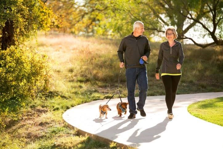 Couple with dogs walking on Canyon Falls' trails