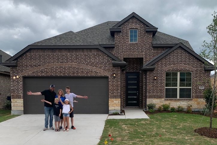 House family standing in front of their new Canyon Falls home