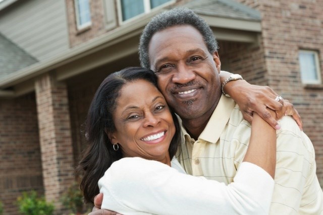 happy-couple-standing-outside-home.jpg