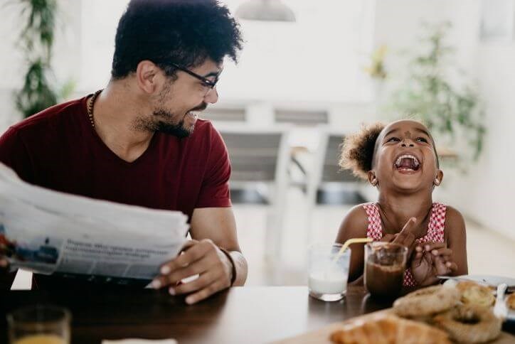 Happy dad and daughter laughing at the kitchen counter | Canyon Falls, a new home community in Flower Mound, TX