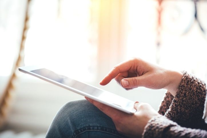 Unrecognizable woman looking at her tablet