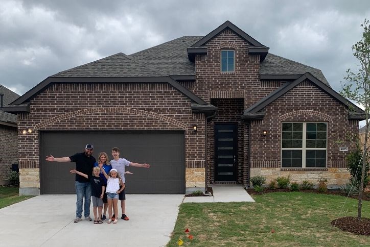 House family standing in front of their new Canyon Falls home