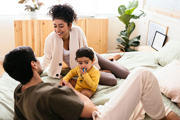 Family relaxing in new home in Canyon Falls community Norhlake, TX